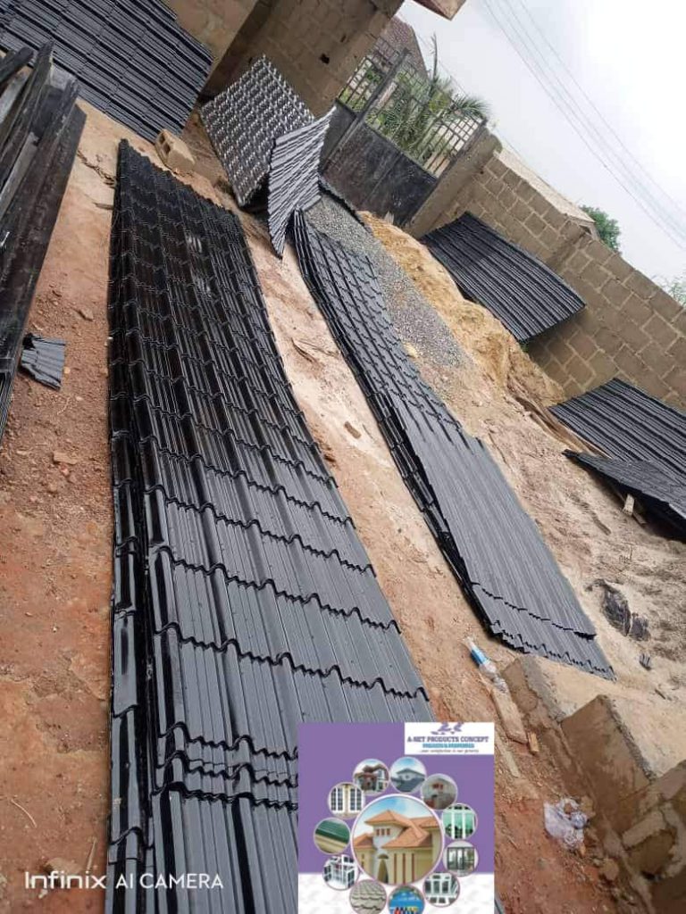 Current image: Aluminium roofing sheets coming out from a fabricating machine, an essential material for building a strong foundation.